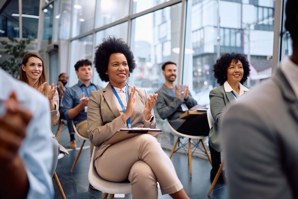 happy-black-businesswoman-applauding-on-a-conferen-P3XZKKL.jpg
